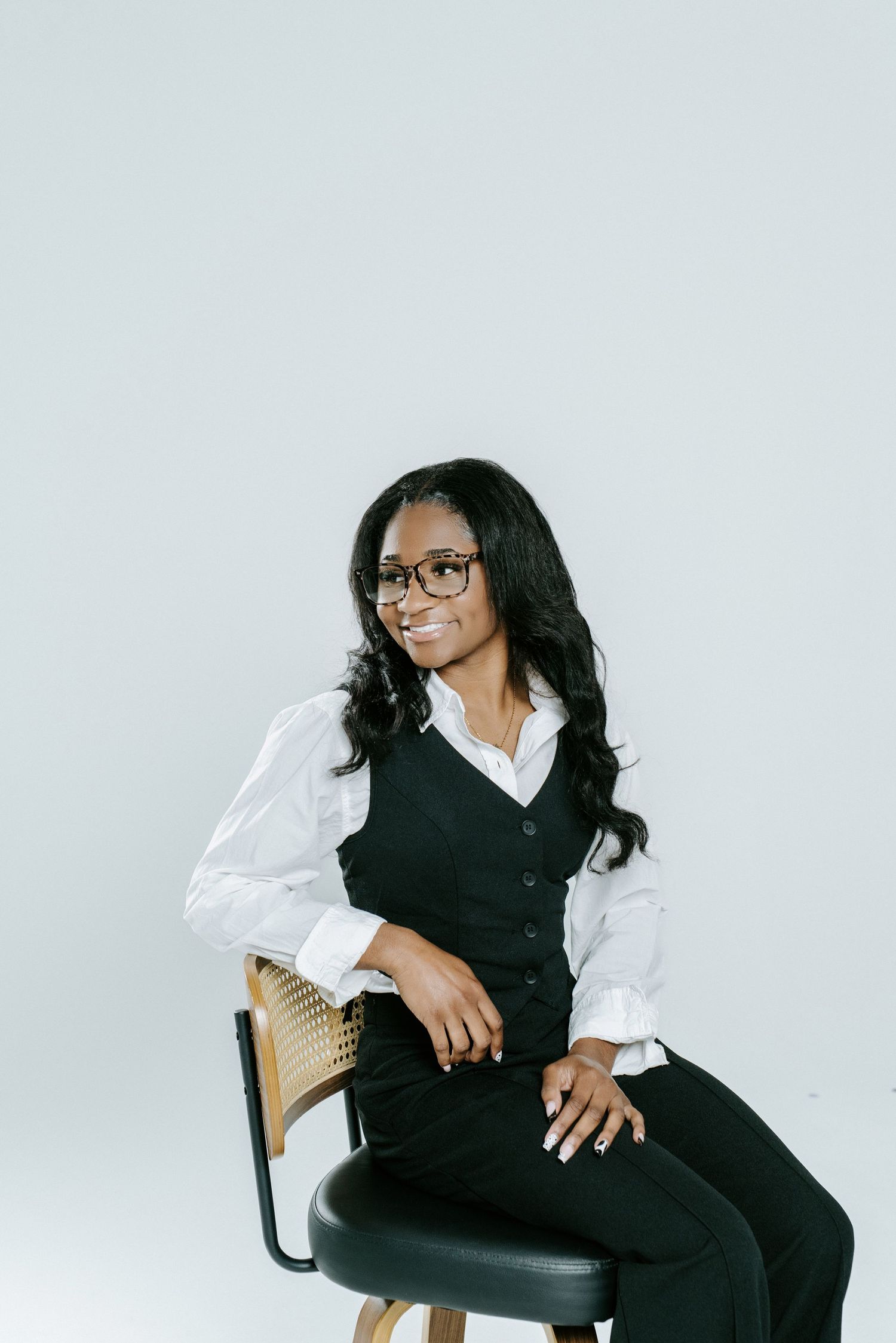 Professional studio portraits showing relaxed poses in business attire against a light gray backdrop.