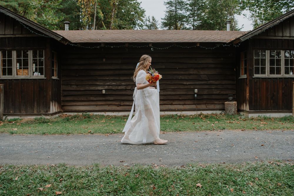 A sequence of photos showing a bride walking outside a rustic wooden lodge on a gravel path.