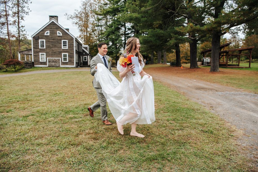 A series of wedding moments at a rustic country venue lined with autumn trees and a gravel path.