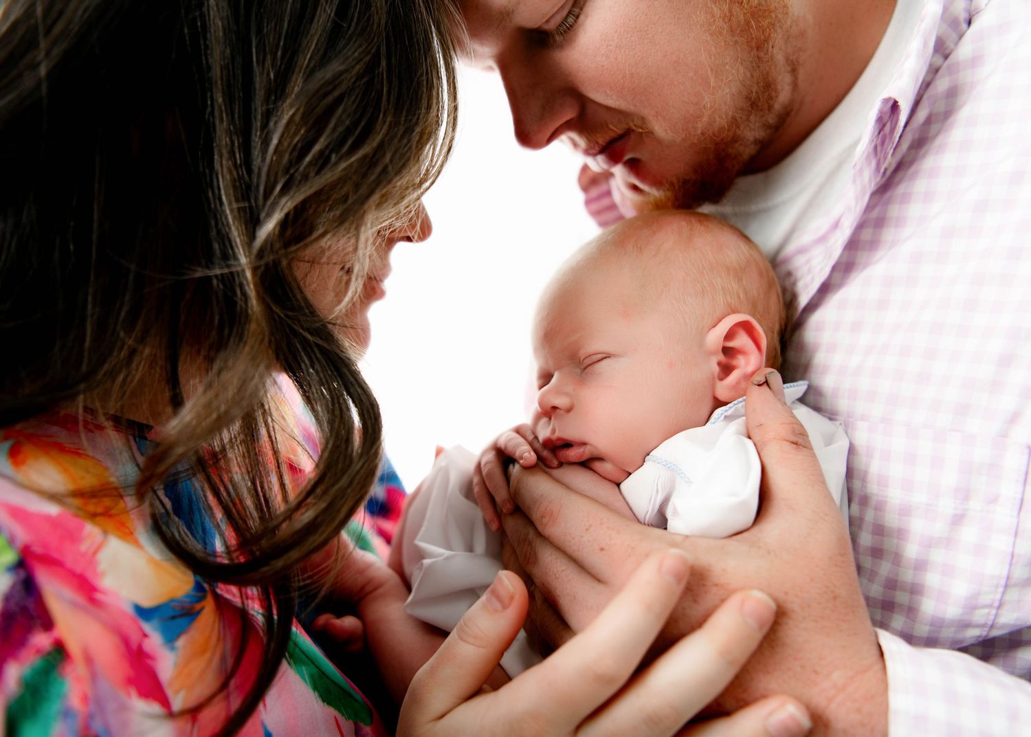 Series of intimate newborn baby photography moments in soft pink and neutral tones.