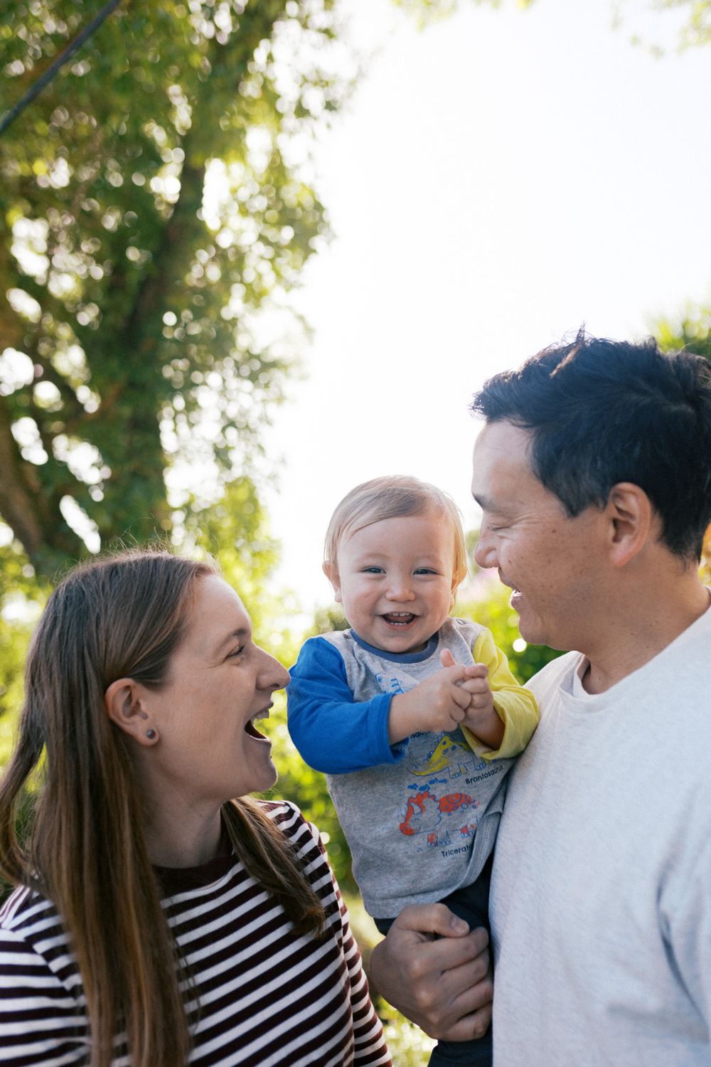 Candid outdoor family photos showing genuine laughter and happiness together.