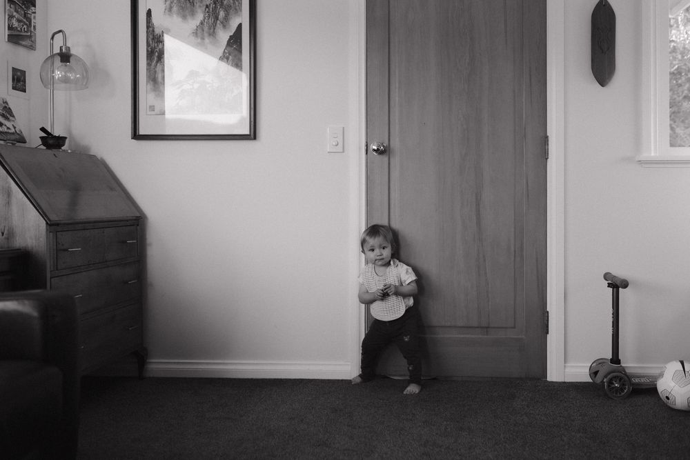 Black and white composition showing interior doors and window shadows in a minimalist hallway.