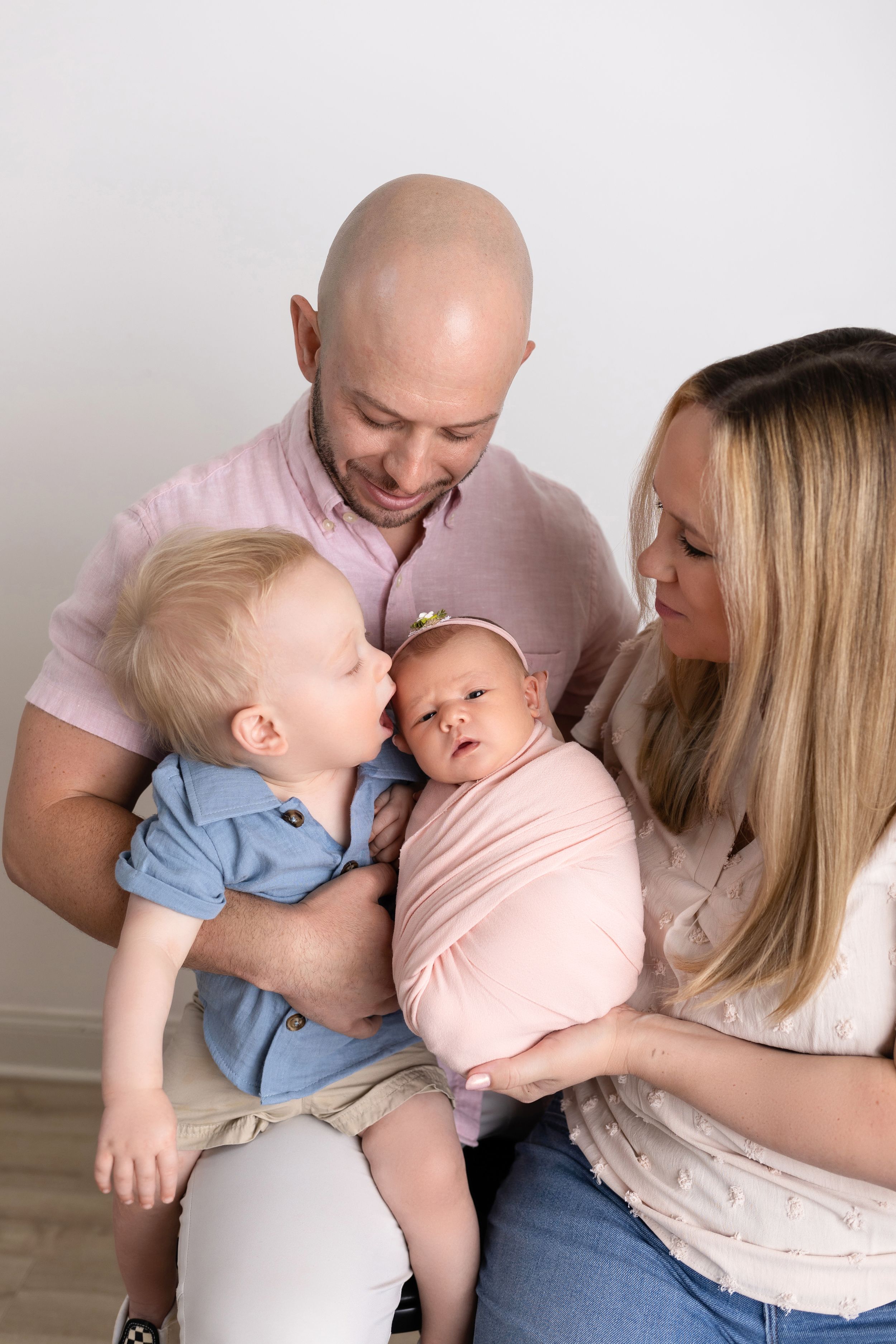 Loving family moment captured in a series of candid portraits showing parents embracing their small children.