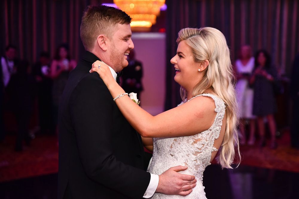 A series of romantic dance floor moments between a bride and groom at their wedding reception.