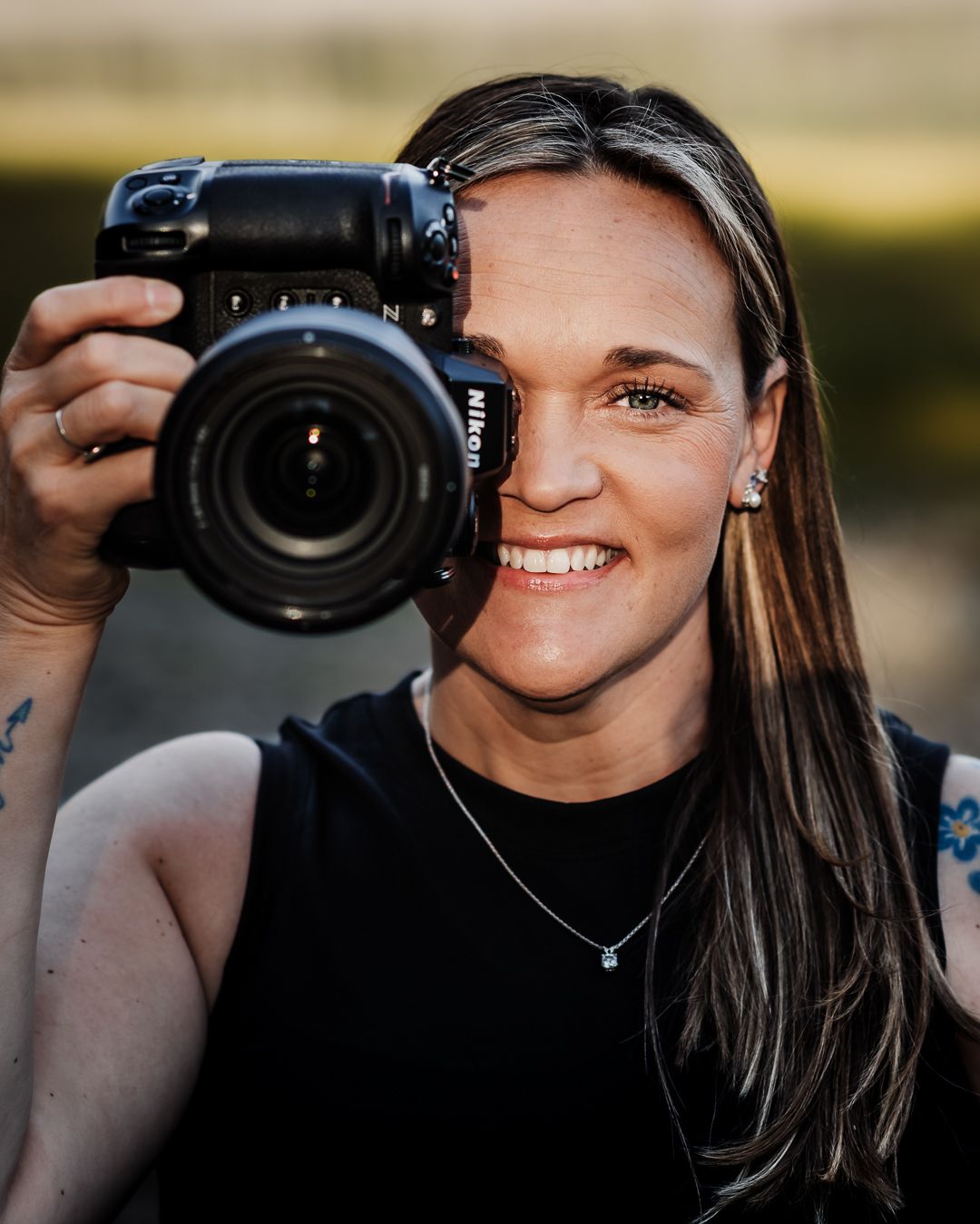 Wandering Roots Collective photographer Nicole Rogers in natural outdoor setting.