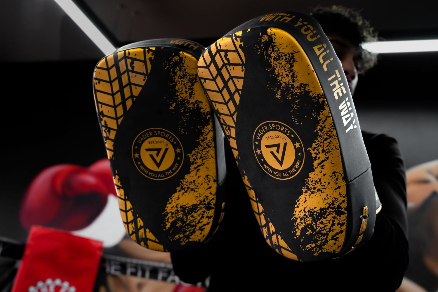 Yellow and black boxing mitts with splatter design pattern.