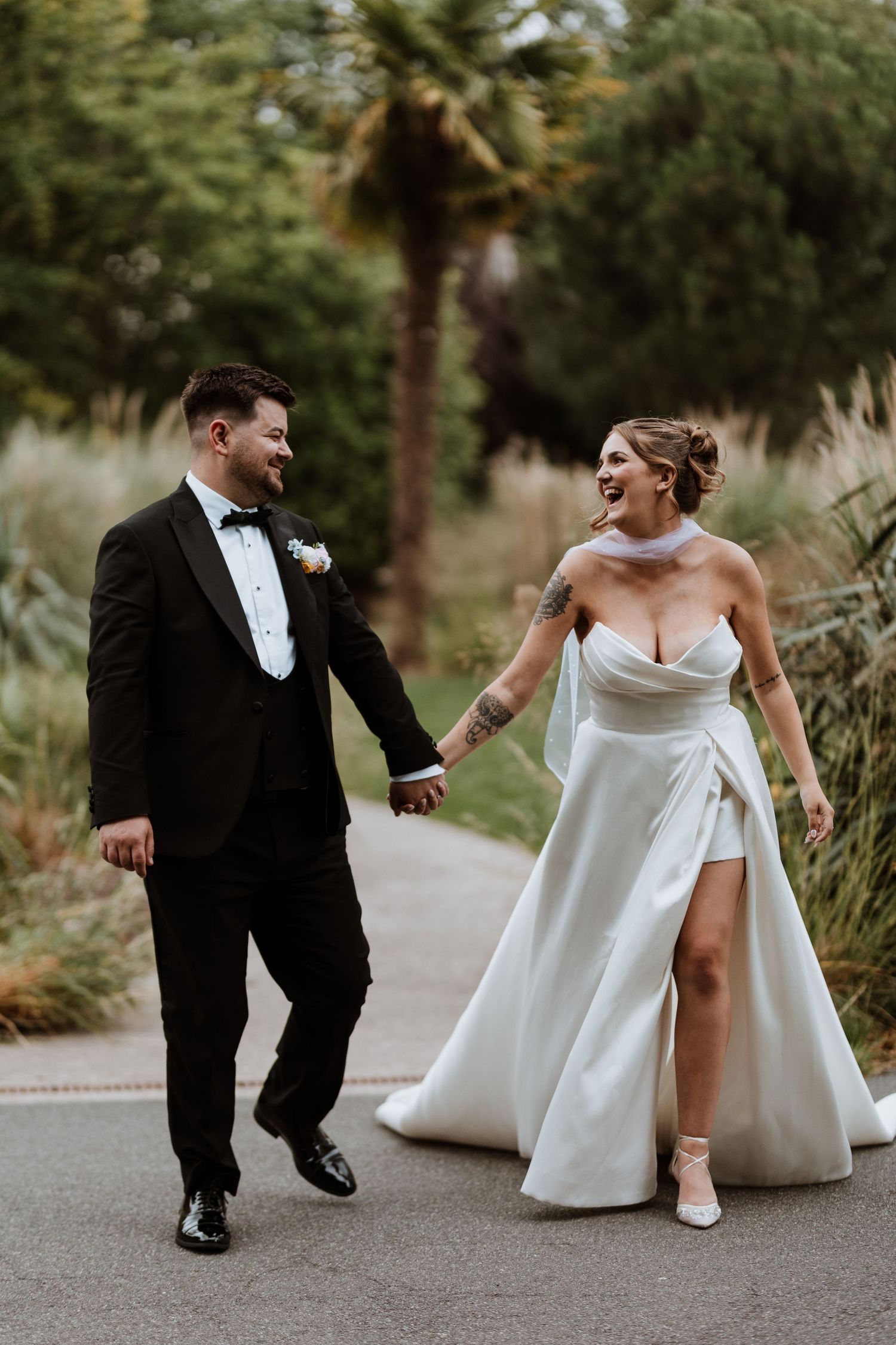 A series of playful wedding photos showing a couple in formal attire posing and interacting on a pathway outdoors at Chester Zoo