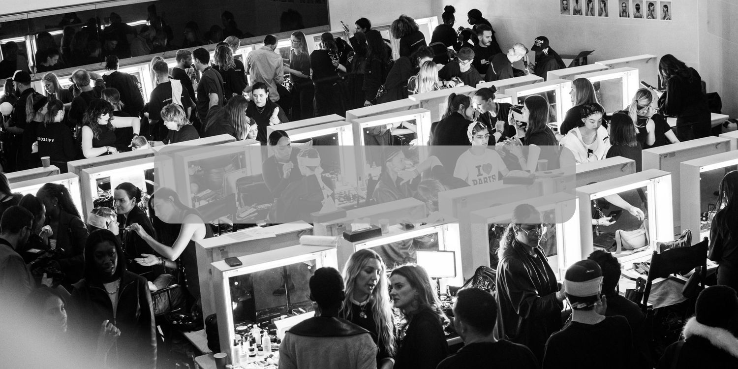 A crowded backstage with people working in a modern corporate setting. London UK