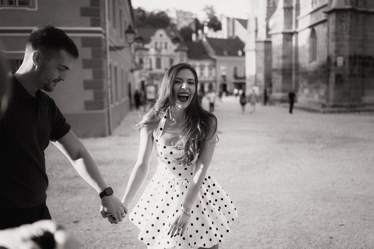 A series of black and white photographs showing a couple in polka dot dress and formal wear walking together outdoors.