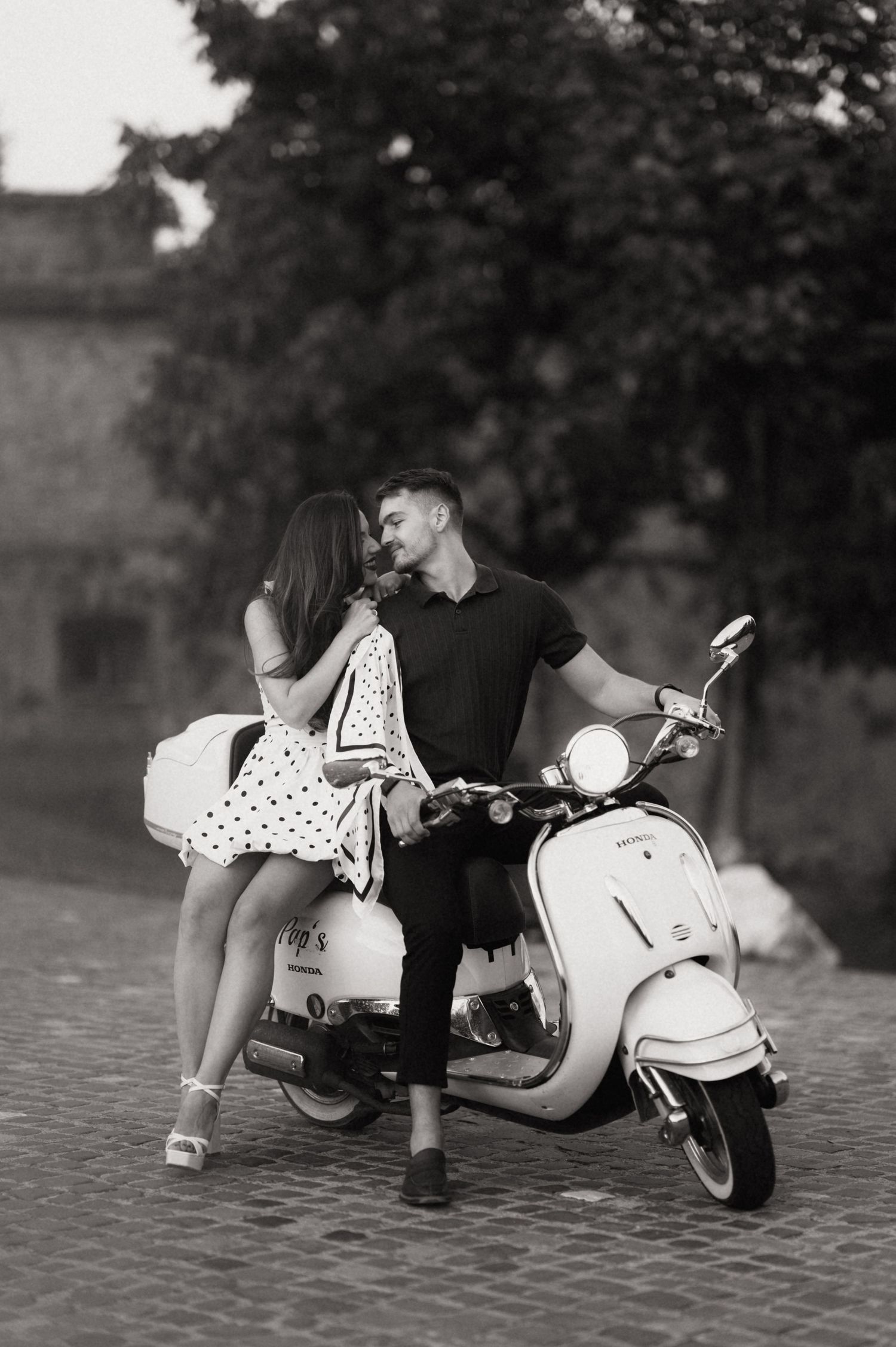 A black and white photo sequence shows a couple lying on the ground in a romantic moment by a lake.