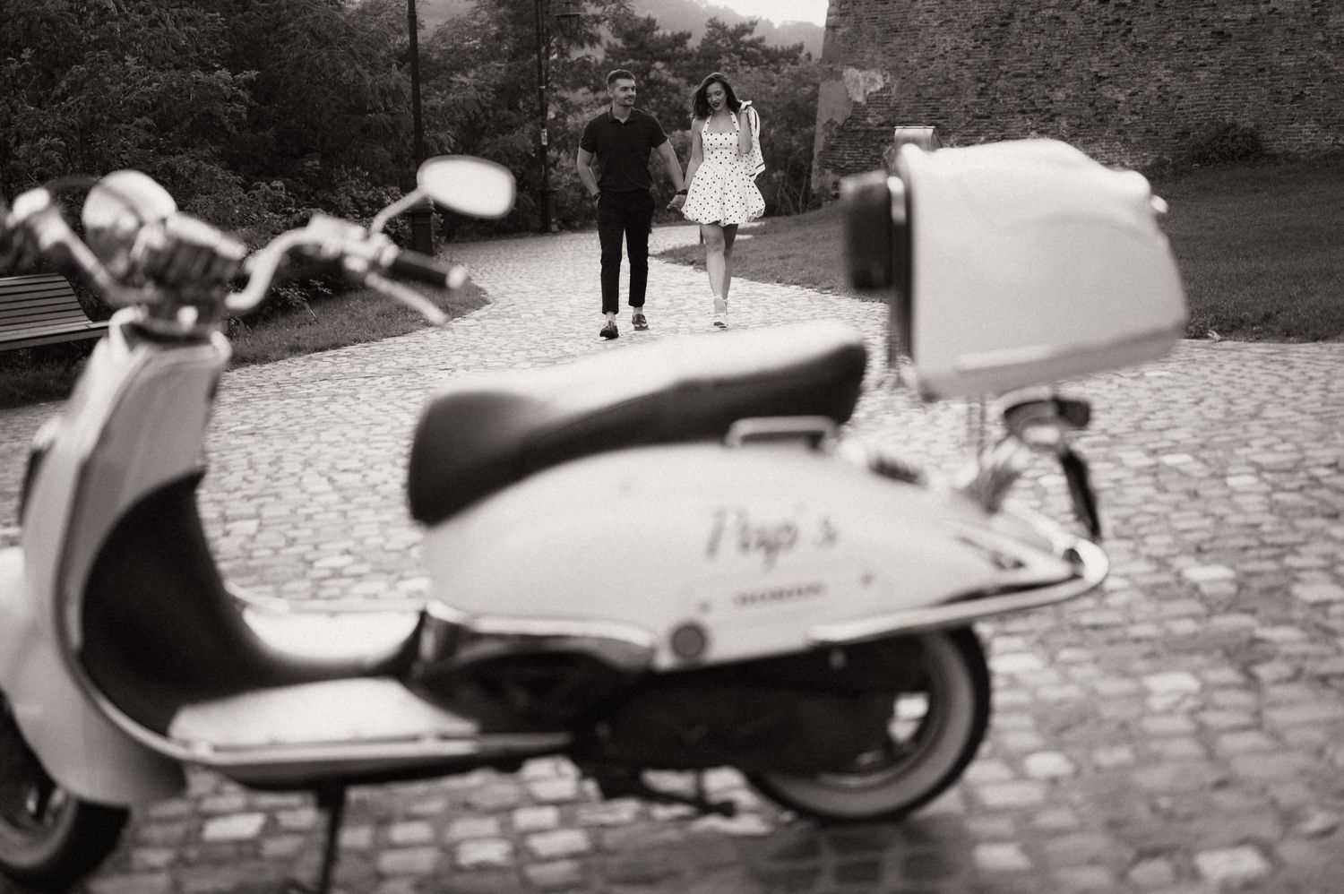 A collection of vintage Vespa scooters parked in a line on a cobblestone street.