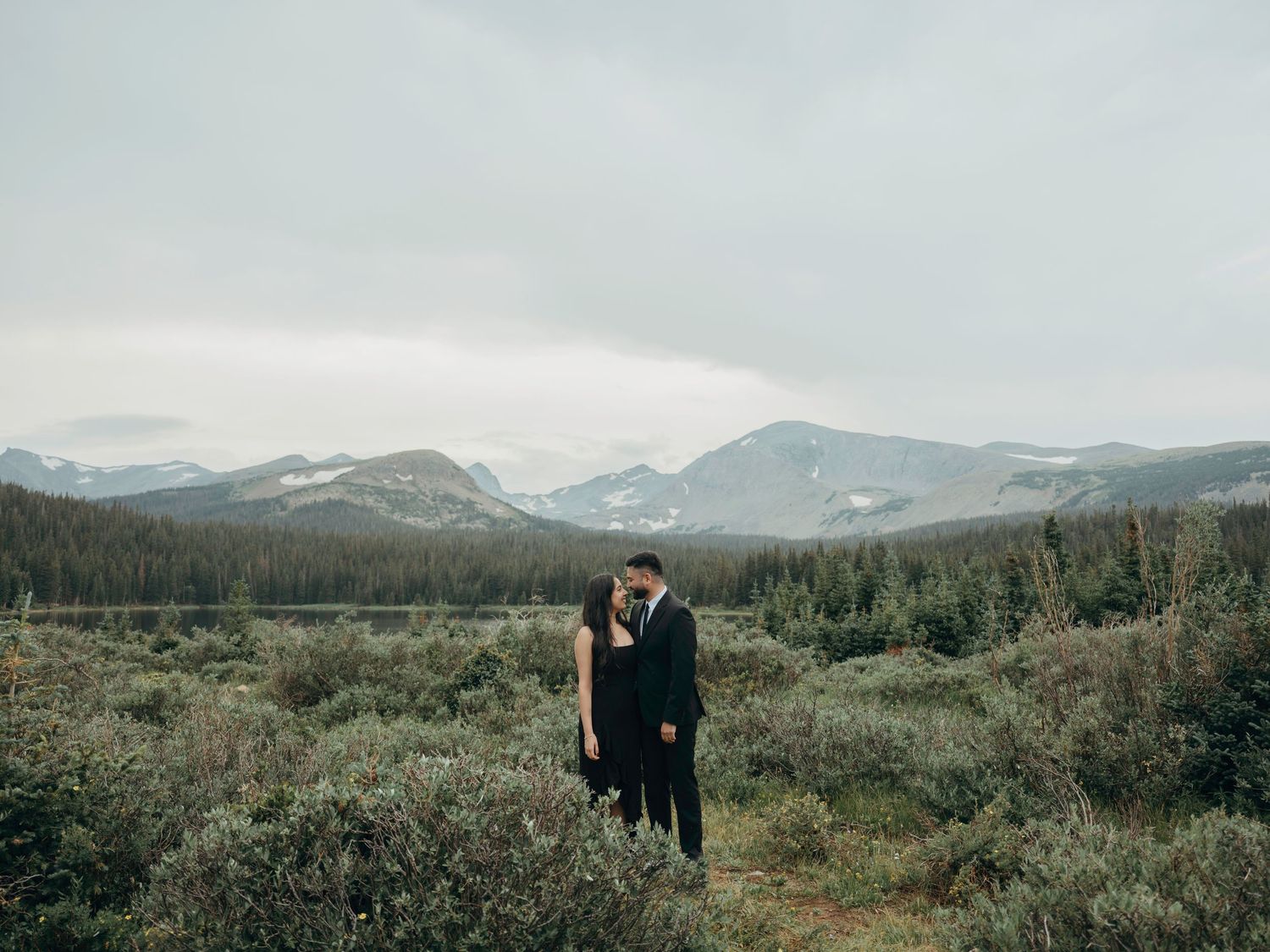 A series of eight scenic mountain landscape photos showing a couple in the distance against majestic snow-capped peaks.