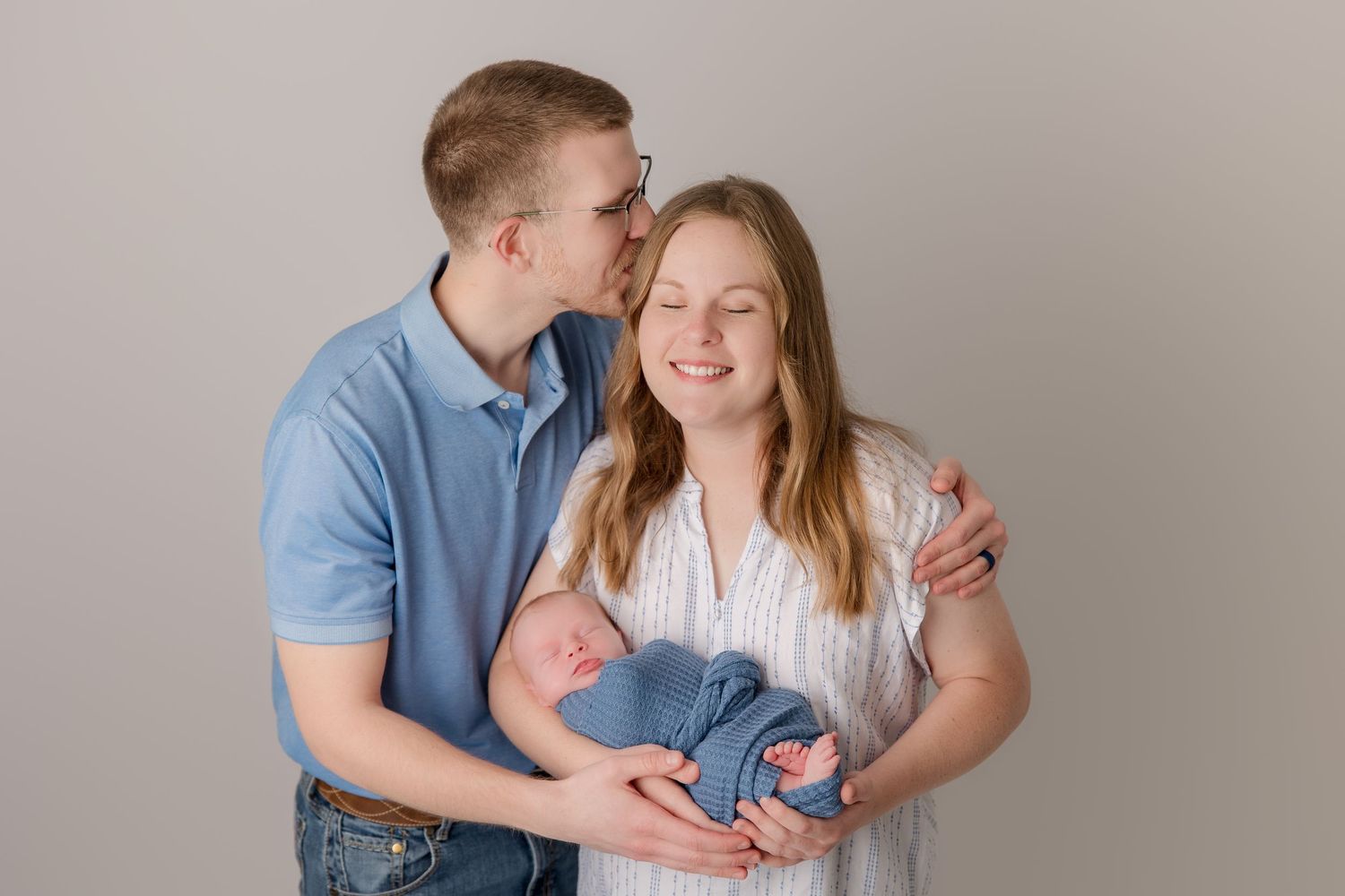 A tender family moment captured in soft neutral tones showing affection and warmth.