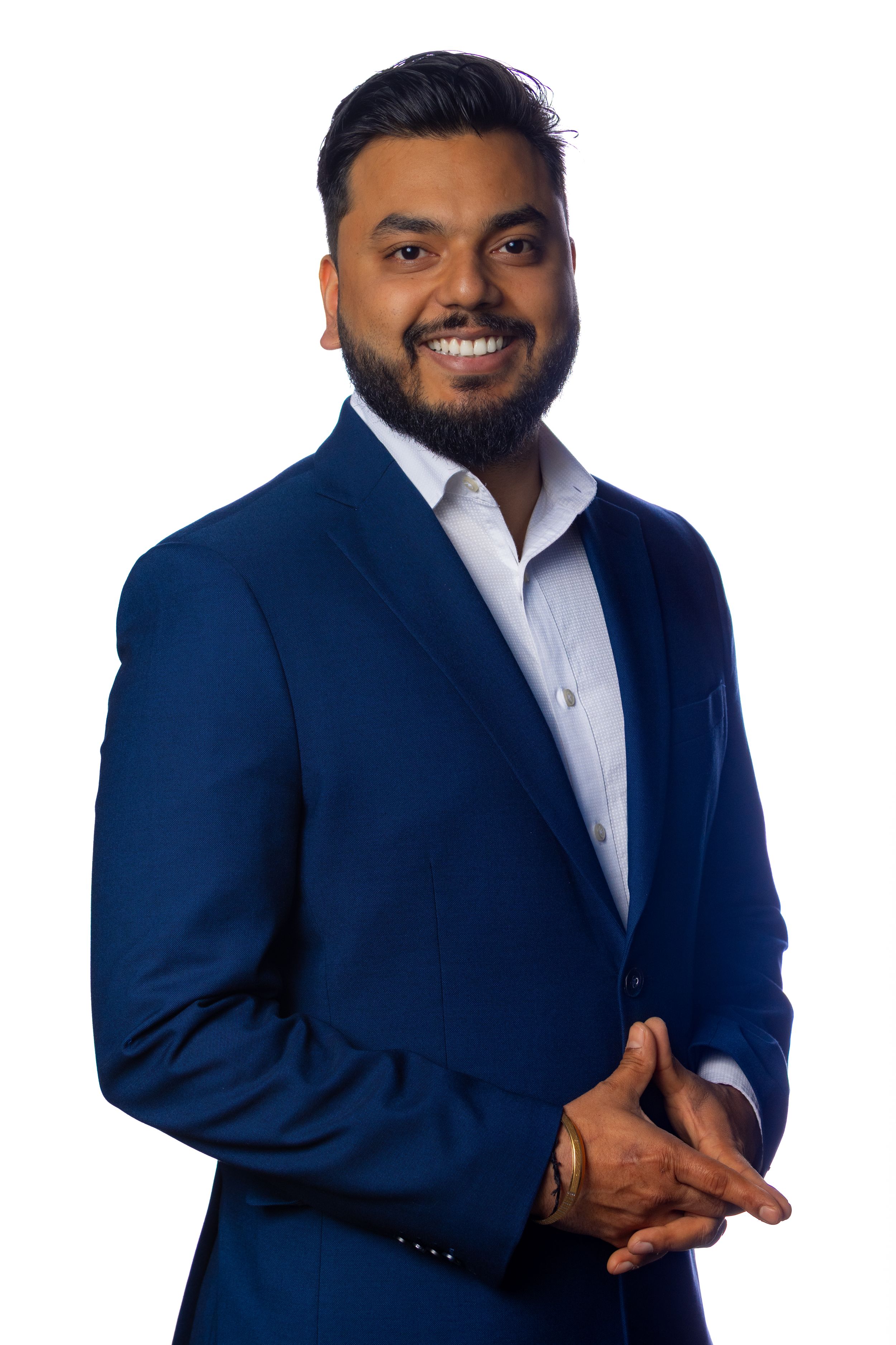 A business professional in a dark blue suit poses confidently against a white background from multiple angles.