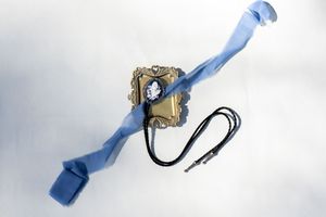 Light blue tie and accessories arranged on white background for wedding detail shot.