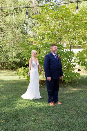 Couple sharing their first look moment in a garden setting before their wedding ceremony.