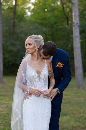 Close-up wedding photography showing intricate lace details of bridal gown and veil.