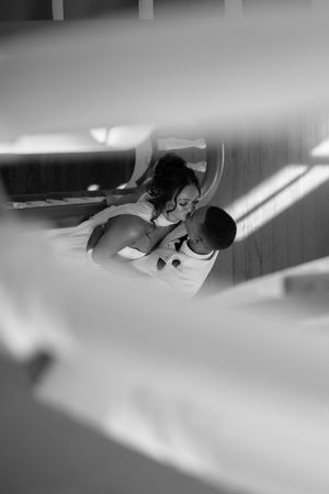 Creative black and white perspective of wedding couple's first look through architectural elements.
