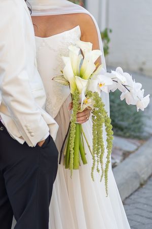 Wedding bouquet featuring white calla lilies and cascading green amaranthus.