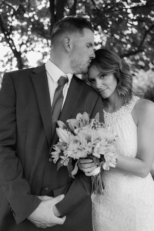 Black and white wedding portrait series showing tender moments between newlyweds.