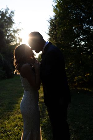 Silhouetted wedding couple portraits at sunset in an outdoor setting.