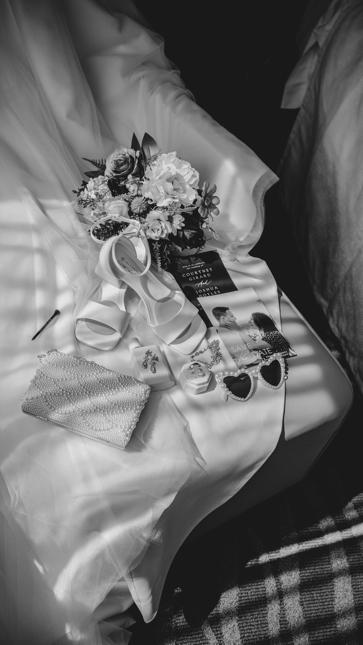 Black and white photo series of elegant wedding accessories including shoes, flowers and satin fabrics on dark background.