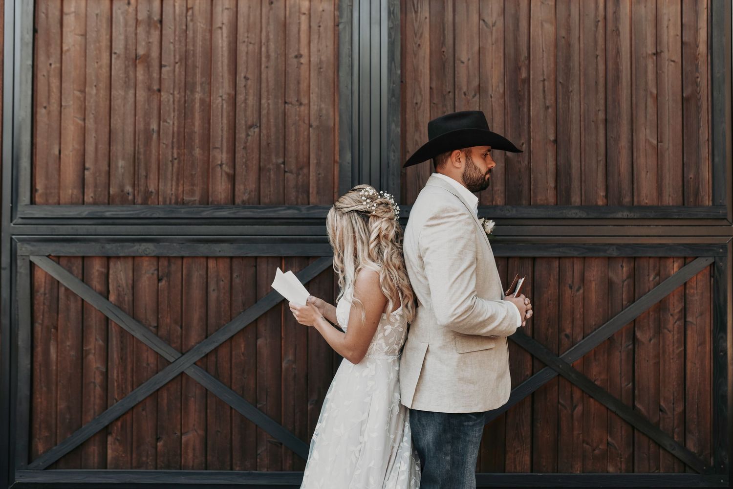 Bride and groom holding hands in front of the barn  for first touch – April Pinto Photography