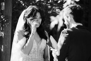 Black and white photo capturing joyful moments during outdoor wedding dance.