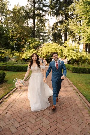 Wedding photo series on a brick pathway surrounded by lush green gardens and trees.