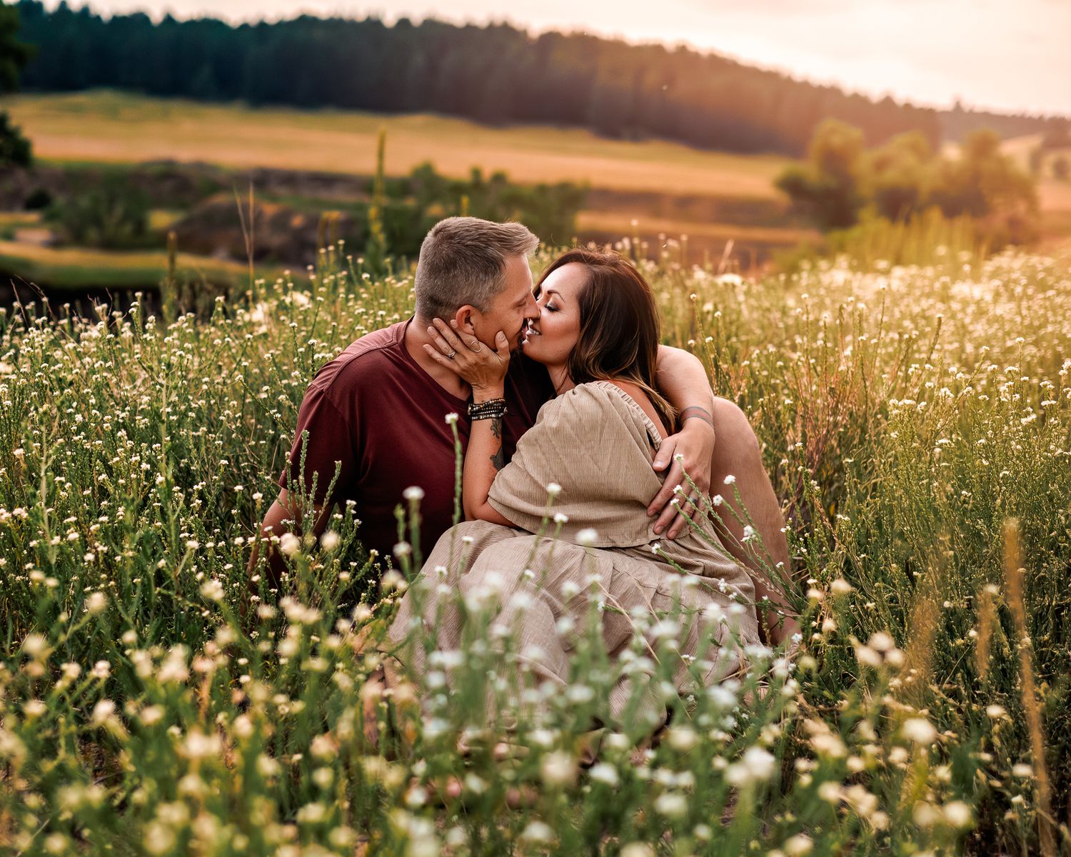 a couple kissing amongst the wildflowers of Castlewood canyon state park