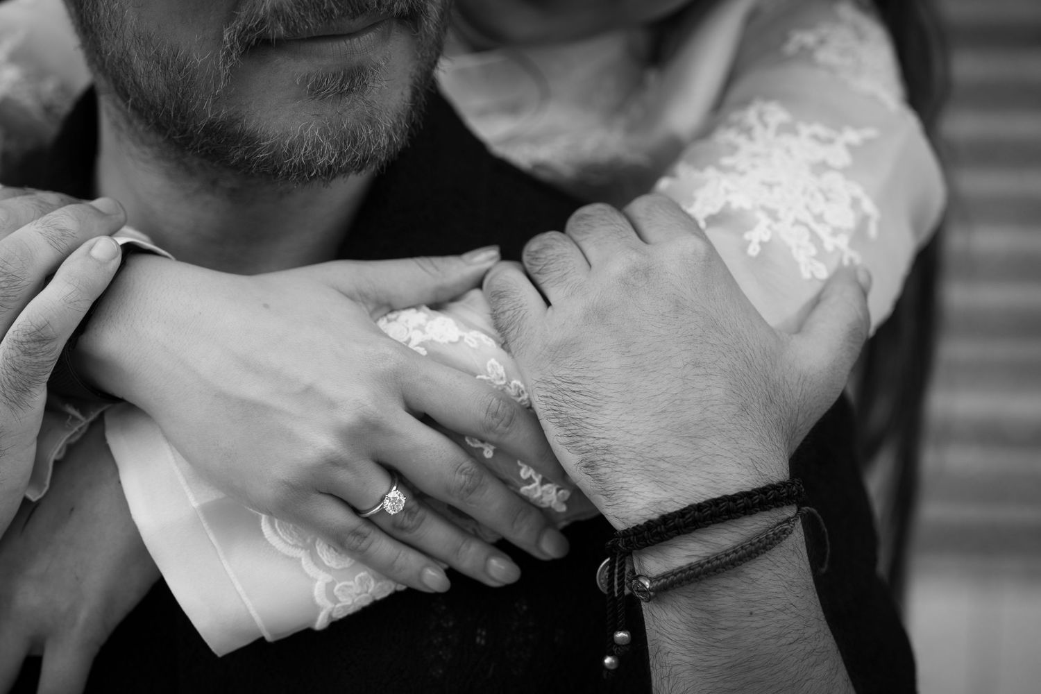 Close-up black and white detail shots of affectionate hand holding moments.