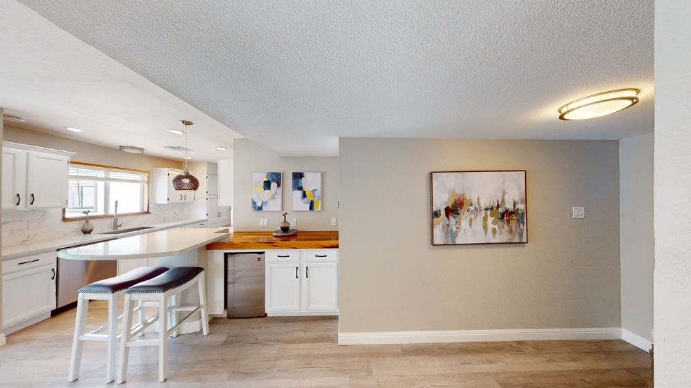 Modern apartment interior with light hardwood floors and white walls shown in a collage of connected rooms.