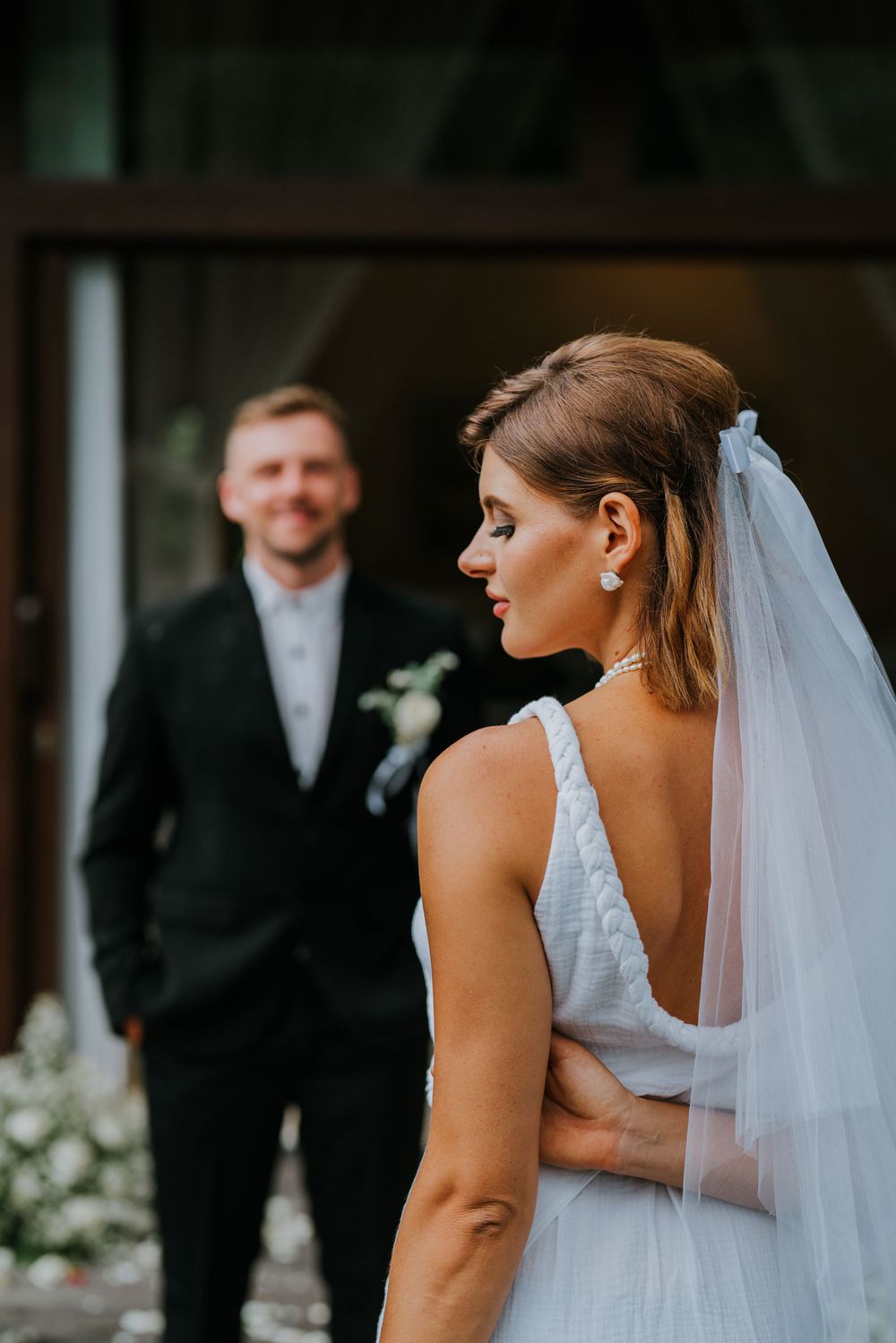 Wedding couple photographed from behind in an intimate moment during their ceremony.