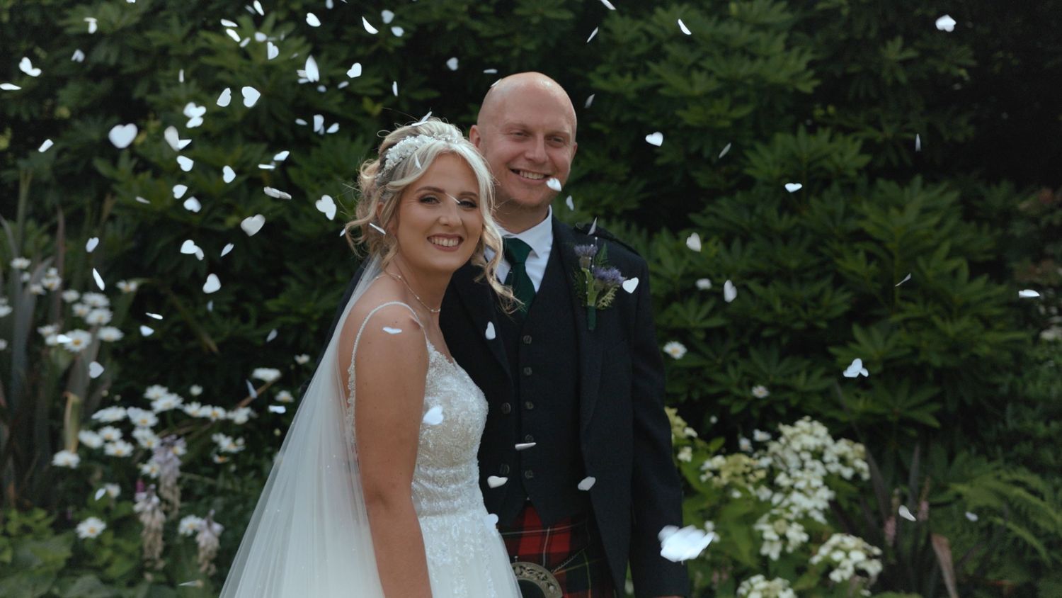 Bride and Groom smiling in confetti at Ardwell Glasshouse, Dumfries and Galloway