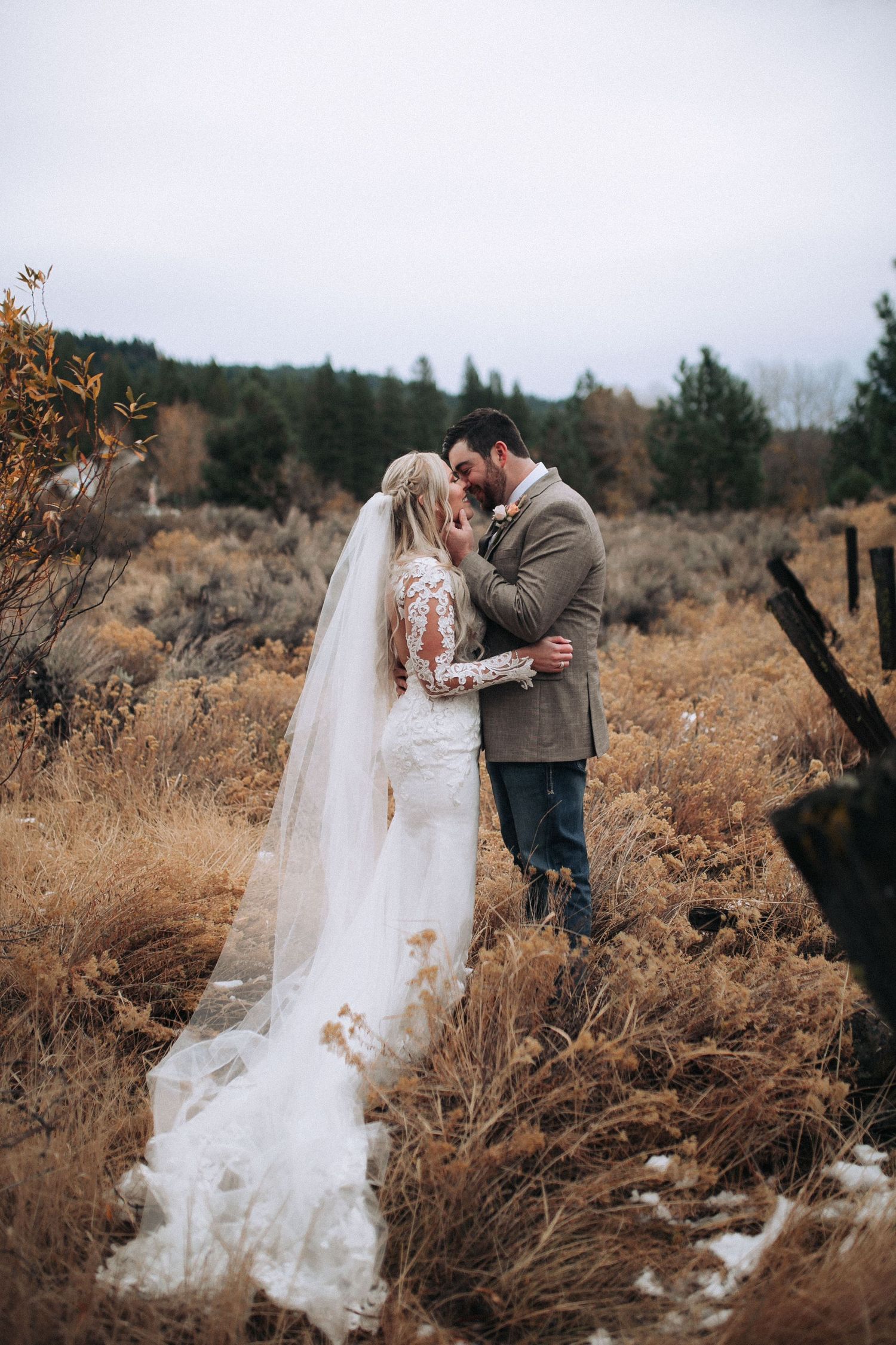 Bride and groom walking together in a wide-open Idaho field at sunset