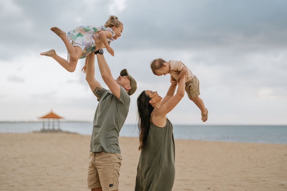 Playful moments captured on a cloudy beach day.
