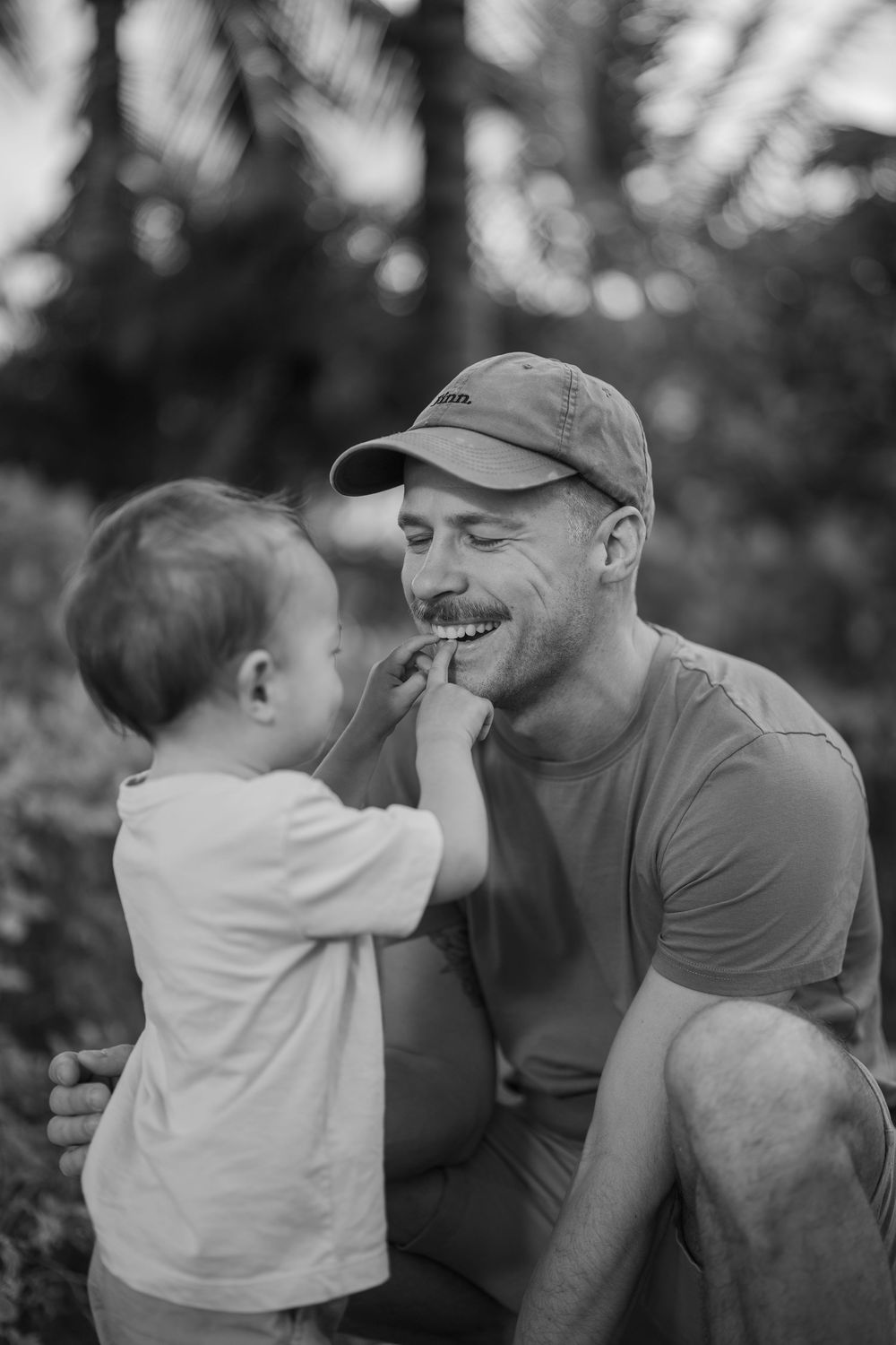 Heartwarming black and white sequence capturing intimate family interactions outdoors.