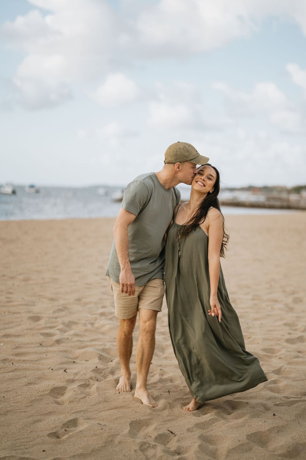 Romantic couple sharing tender moments together on a sandy beach.