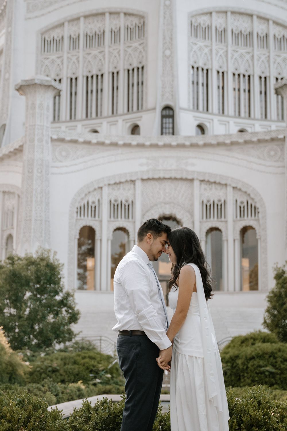 A couple shares romantic moments in front of the majestic white Bahai Temple in Wilmette, Illinois.