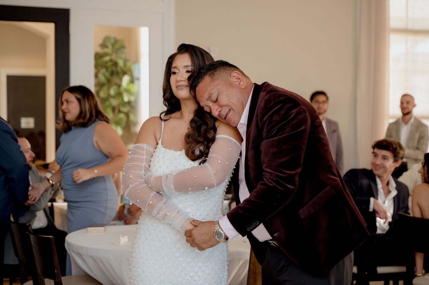 Couples dancing together at an elegant indoor wedding reception venue.