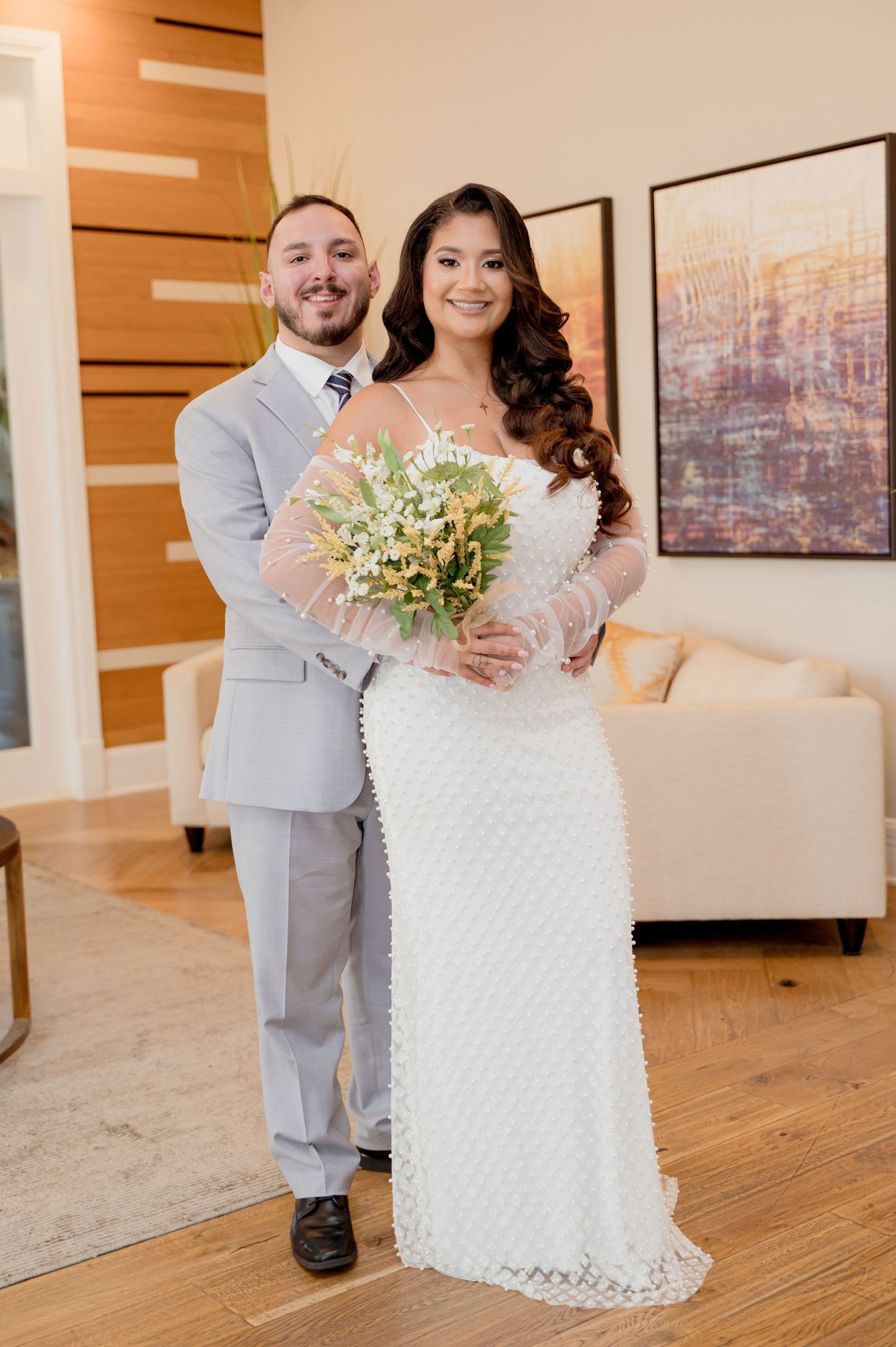 Elegant wedding celebration in a bright indoor venue with hardwood floors and modern decor.