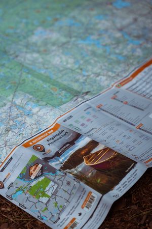 Seven images of folded maps and travel guides lying on a textured surface, arranged in a sequential progression.