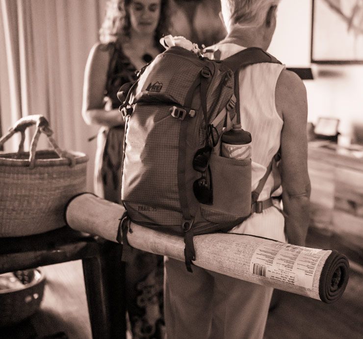 Vintage monochrome image of travel gear including backpack and rolled up mat.