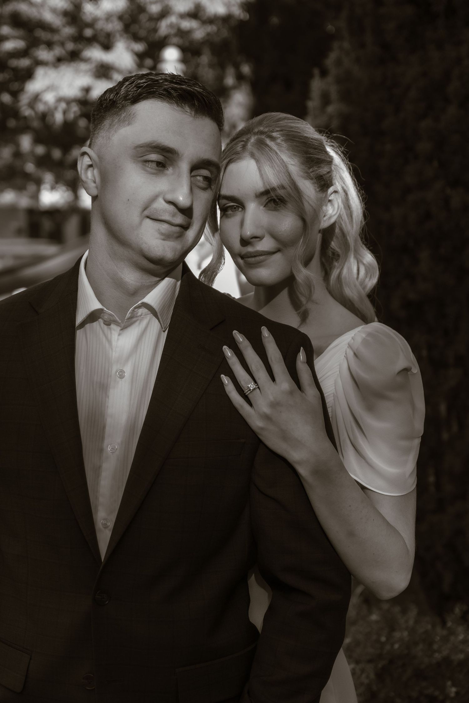 Black and white romantic wedding portraits showing intimate moments between a couple.