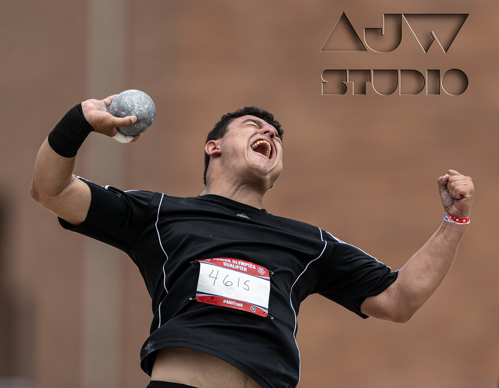 Shot putter celebrates enthusiastically during competition throw.