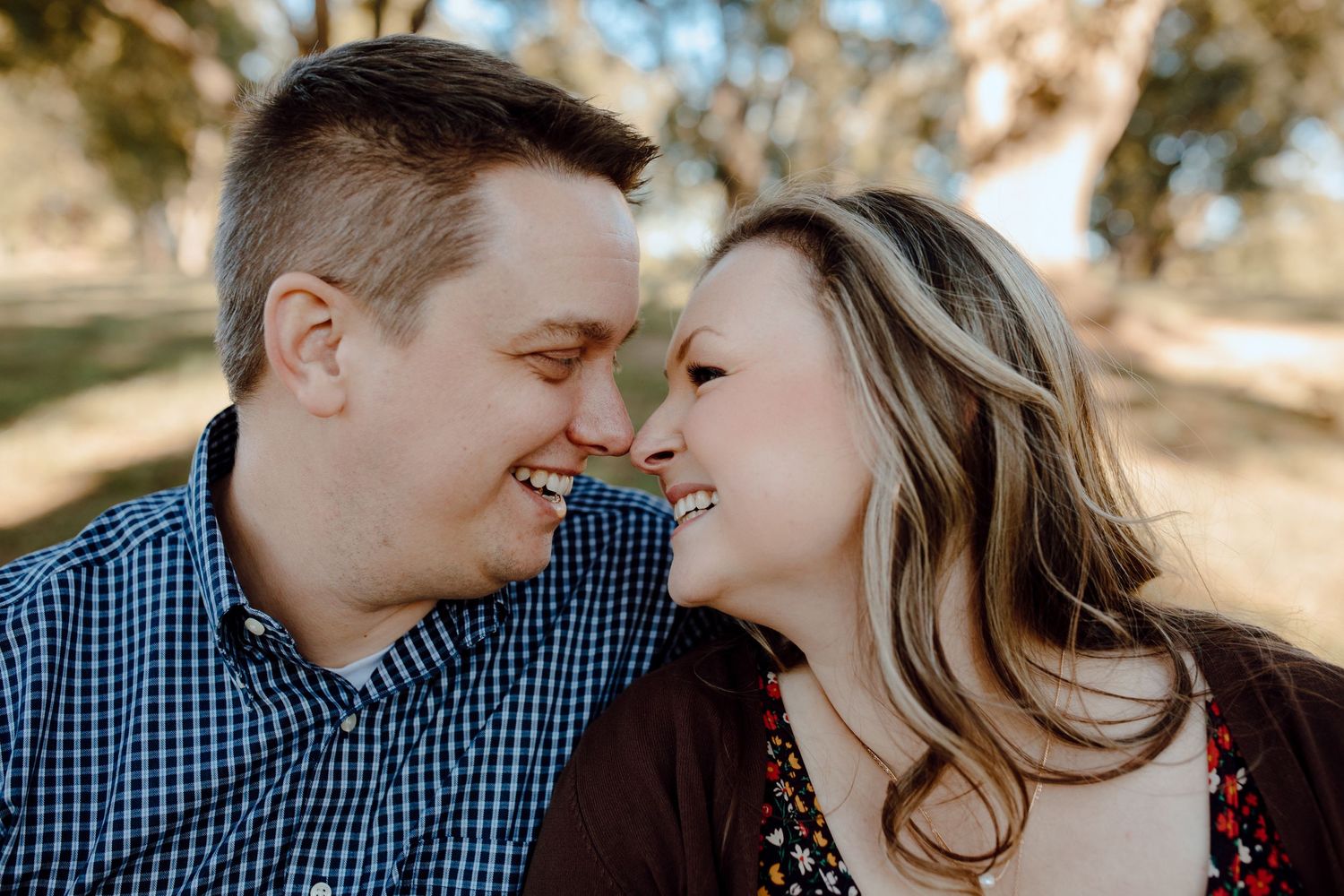 Couple sharing an intimate moment outdoors.