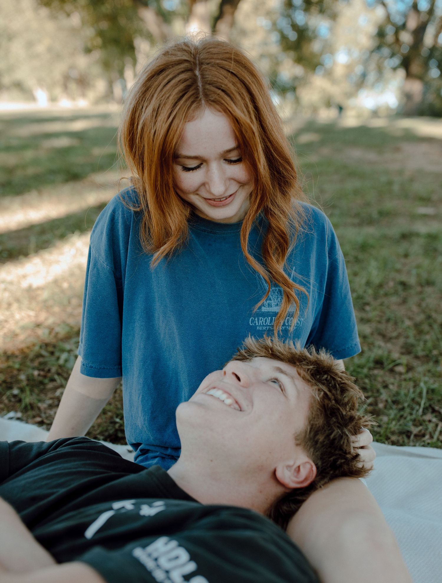 Couple sharing a tender moment while relaxing outdoors.
