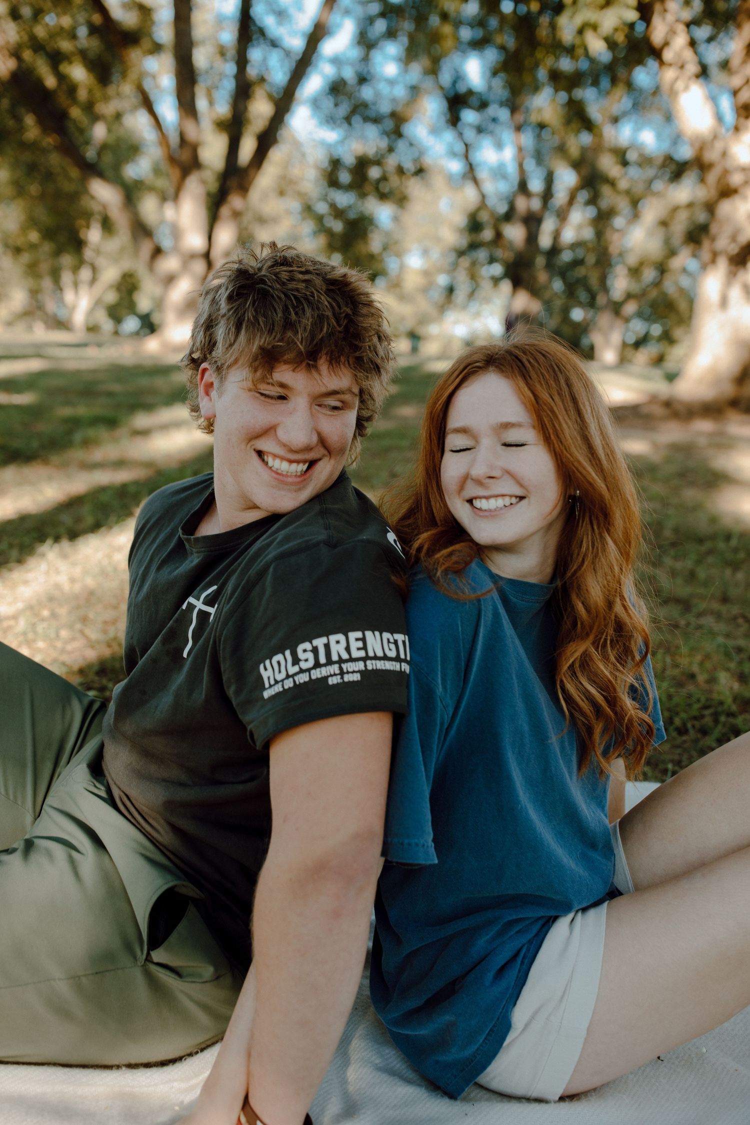 Couple in casual t-shirts enjoying a sunny day in the park.