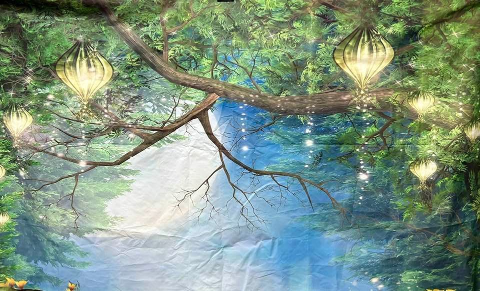 Glowing lanterns hanging from tree branches over a mystical blue-tinted forest scene.