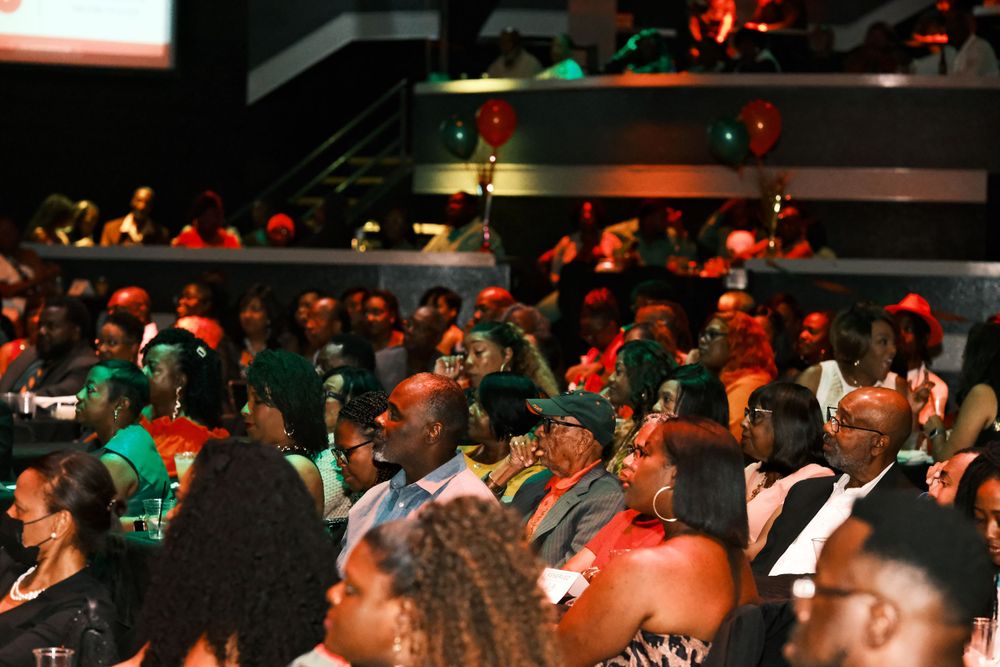 Large audience seated in tiered rows at an indoor entertainment venue.